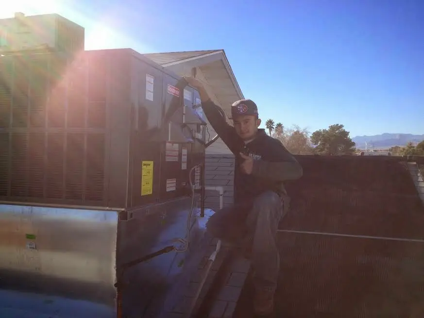 HVAC technician performing Heat Pump Repair on a rooftop unit in West Plains